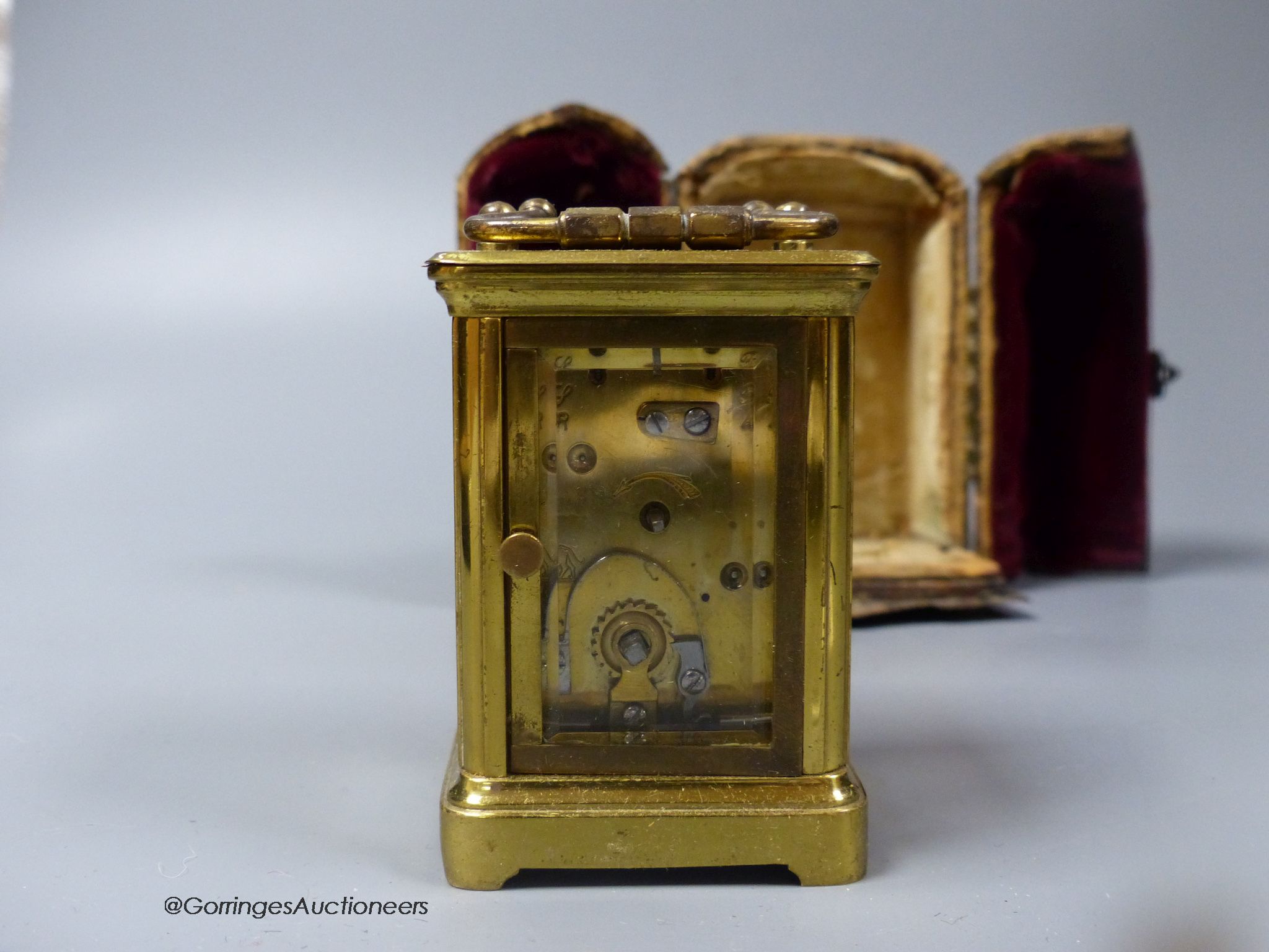 A brass cased carriage timepiece, 7.5cm, in a leather carrying case